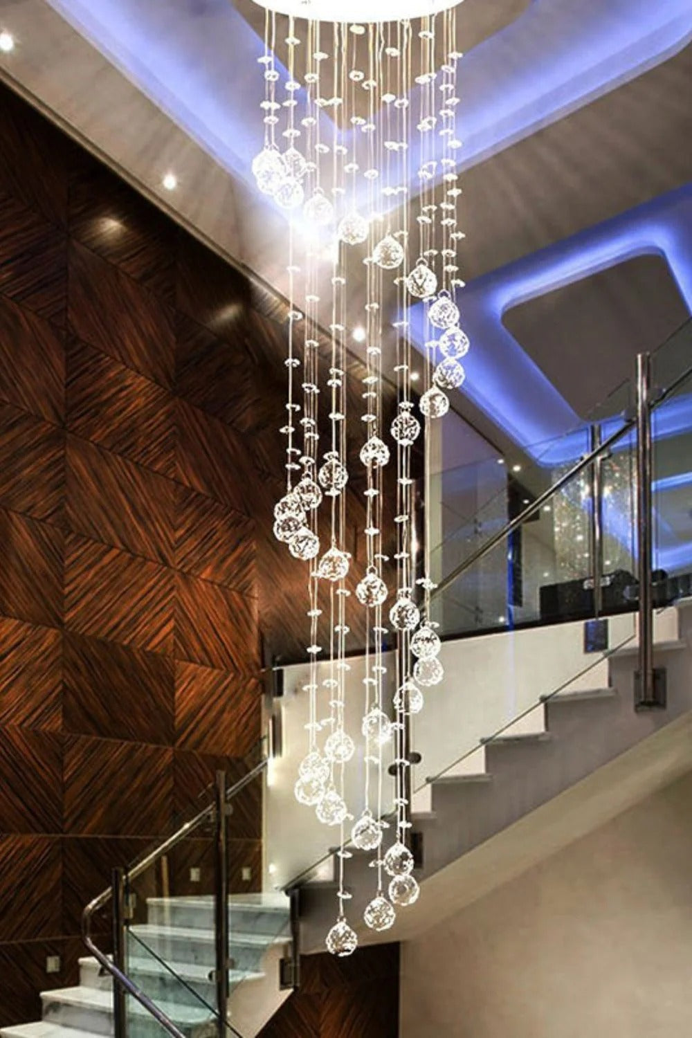 Large Foyer Lighting For High Ceiling and Entryway with spiral raindrop crystals beside a staircase