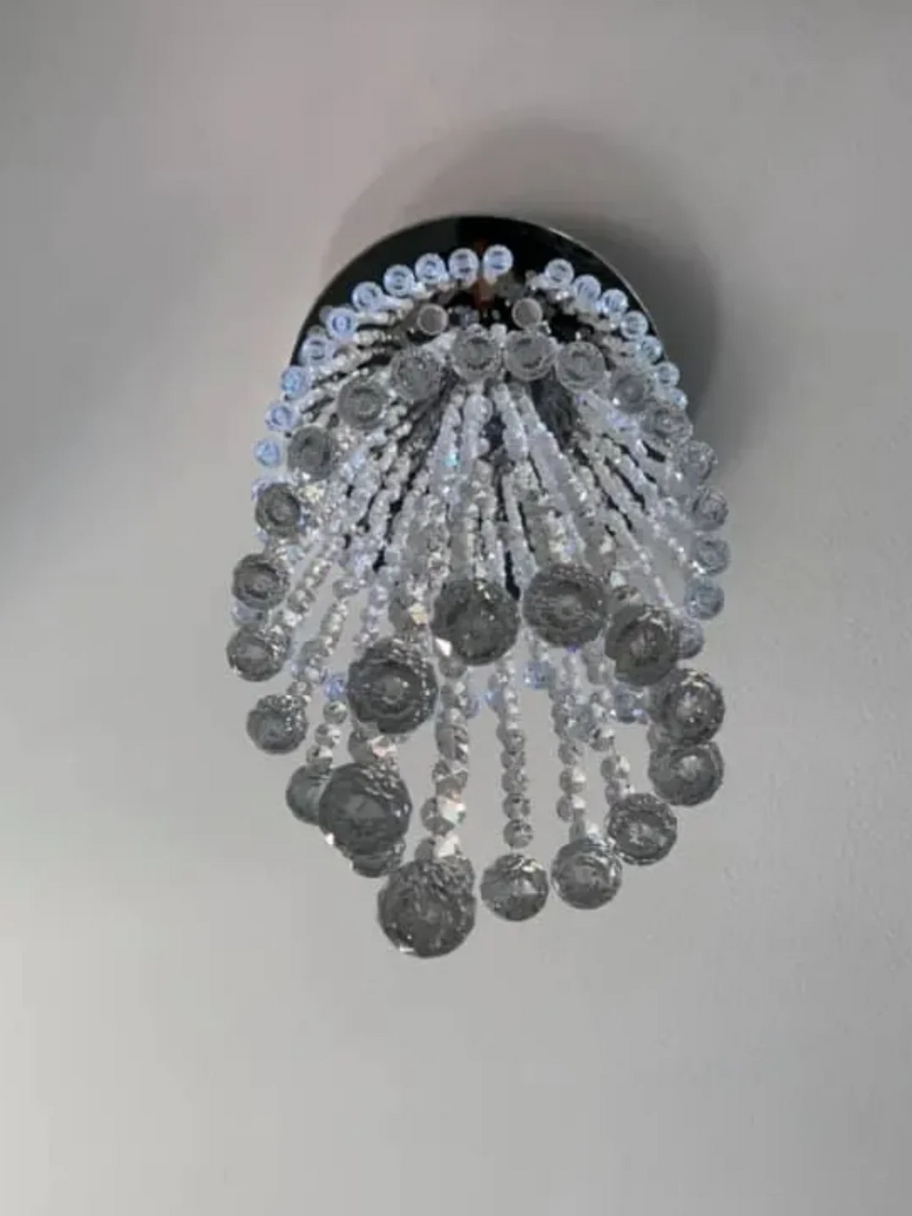 Bottom view of Large Foyer Lighting spiral raindrop crystal chandelier showing round canopy and crystal drops