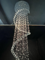 Close up of Large Foyer Lighting spiral raindrop crystal chandelier with illuminated crystal strands
