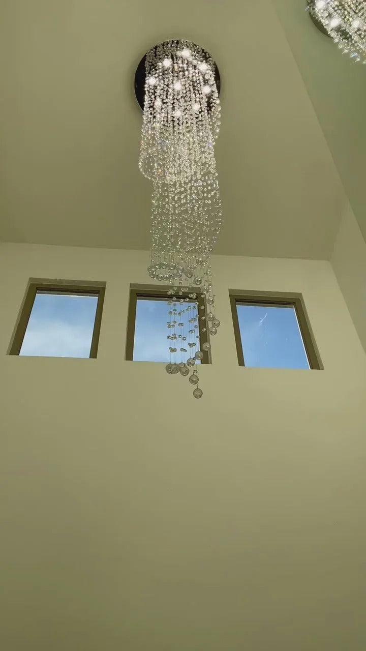 Large Foyer Lighting spiral raindrop crystal chandelier in a tall foyer with upper windows