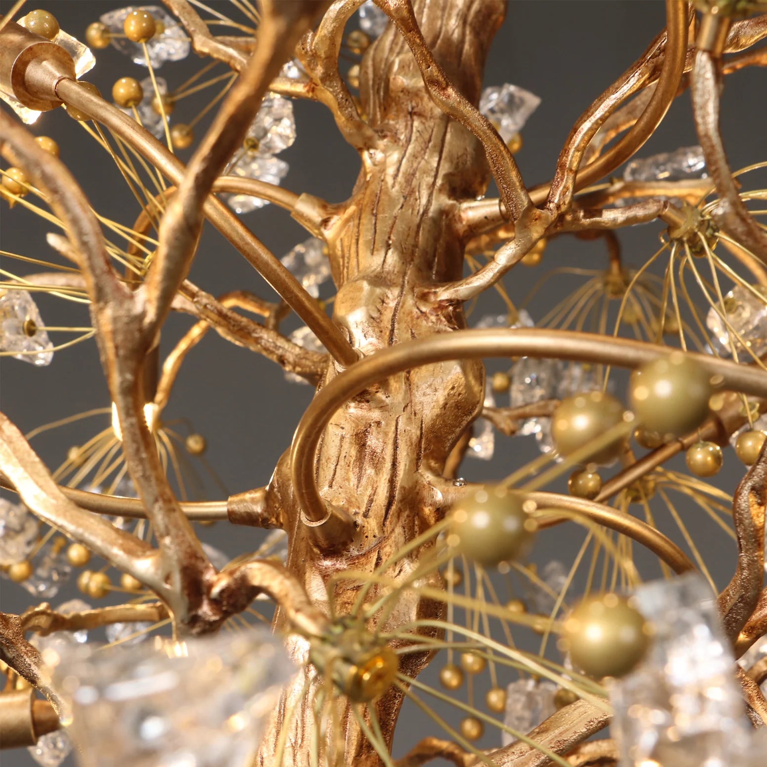 Close up of gold branch frame and glass berry accents on Lorna chandelier