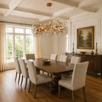 Lorna Berry Branch Shape Glass Chandelier over a rectangular dining table in a coffered room