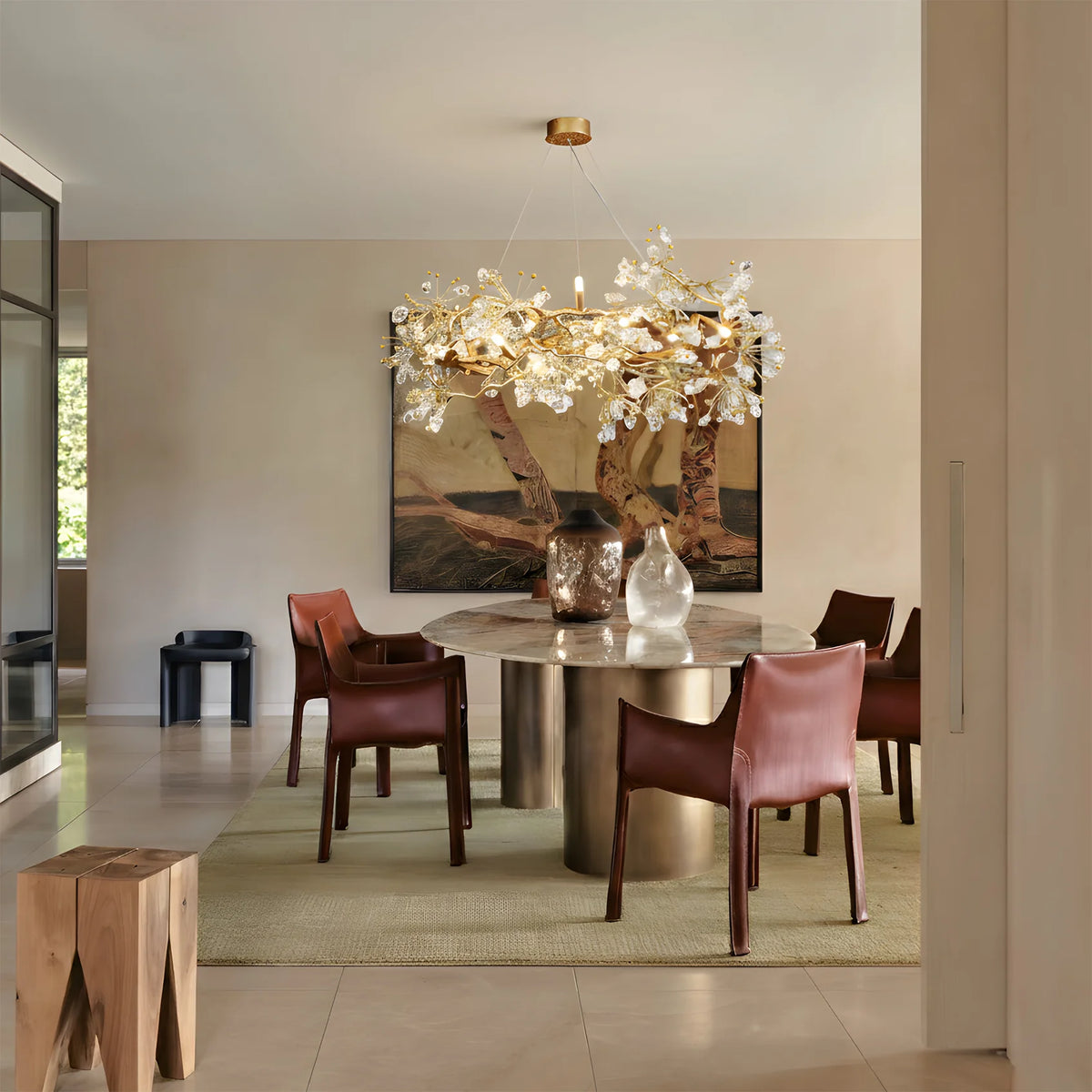 Lorna Berry Branch Shape Glass Chandelier above a round dining table with red chairs