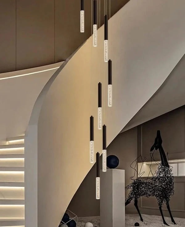 Lum Modern Black Foyer Chandelier For High Ceiling with warm LED tube pendants beside a modern staircase