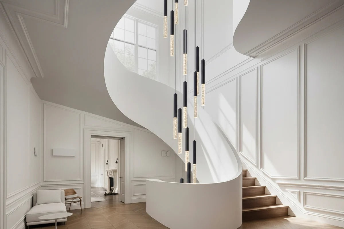 Lum Modern Black Foyer Chandelier For High Ceiling installed beside a white curved staircase with black and white LED tubes