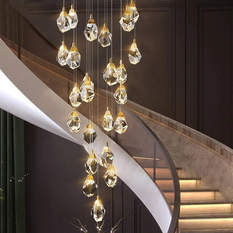 Modern Crystal Chandelier for High Ceiling Living Room with brass finish and faceted crystals over a curved staircase