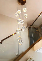 Modern Crystal Chandelier for High Ceiling Living Room in a double height foyer with a cascading crystal cluster