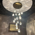 Modern Crystal Chandelier for High Ceiling Living Room with crystal pendants on a round gold ceiling canopy