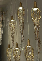 Modern Crystal Glass Drops Chandelier for Staircase installed as a teardrop glass pendant chandelier