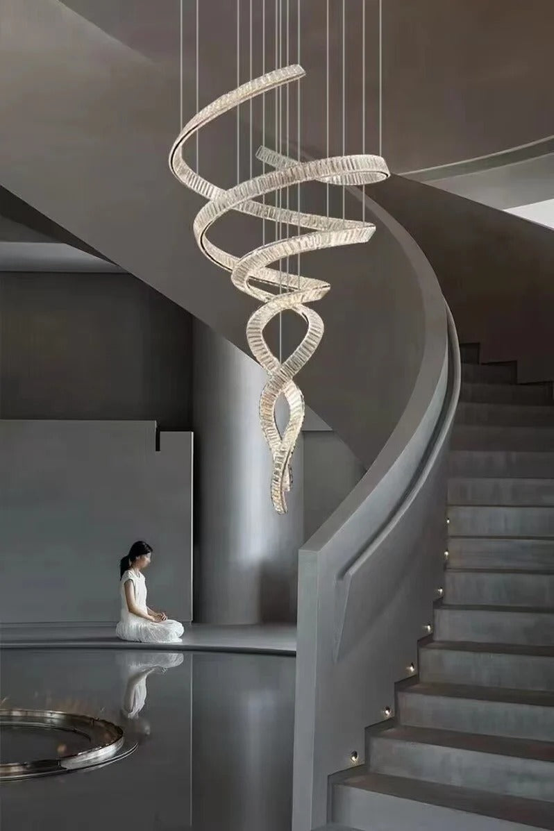 Modern Crystal Light Fixture for Staircase Foyer and High Ceiling installed beside a curved staircase