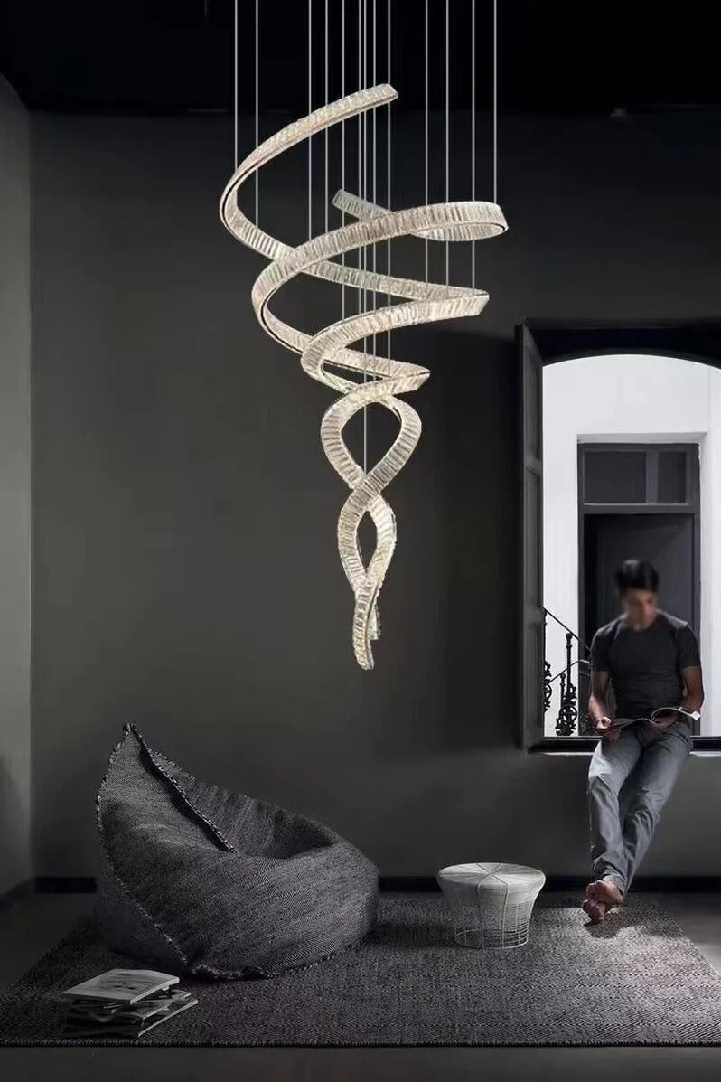 Modern Crystal Light Fixture for Staircase Foyer and High Ceiling suspended in a dark modern room with spiral LED crystals