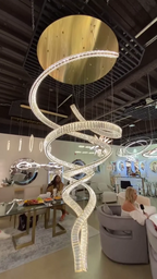 Modern Crystal Light Fixture for Staircase Foyer and High Ceiling with gold canopy displayed in a showroom