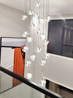 Modern Crystal Square Chandelier for Staircase installed beside a balcony railing with cube crystal drops