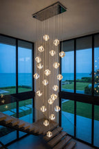 Modern Crystal Square Chandelier for Staircase hanging in a double height space beside tall windows