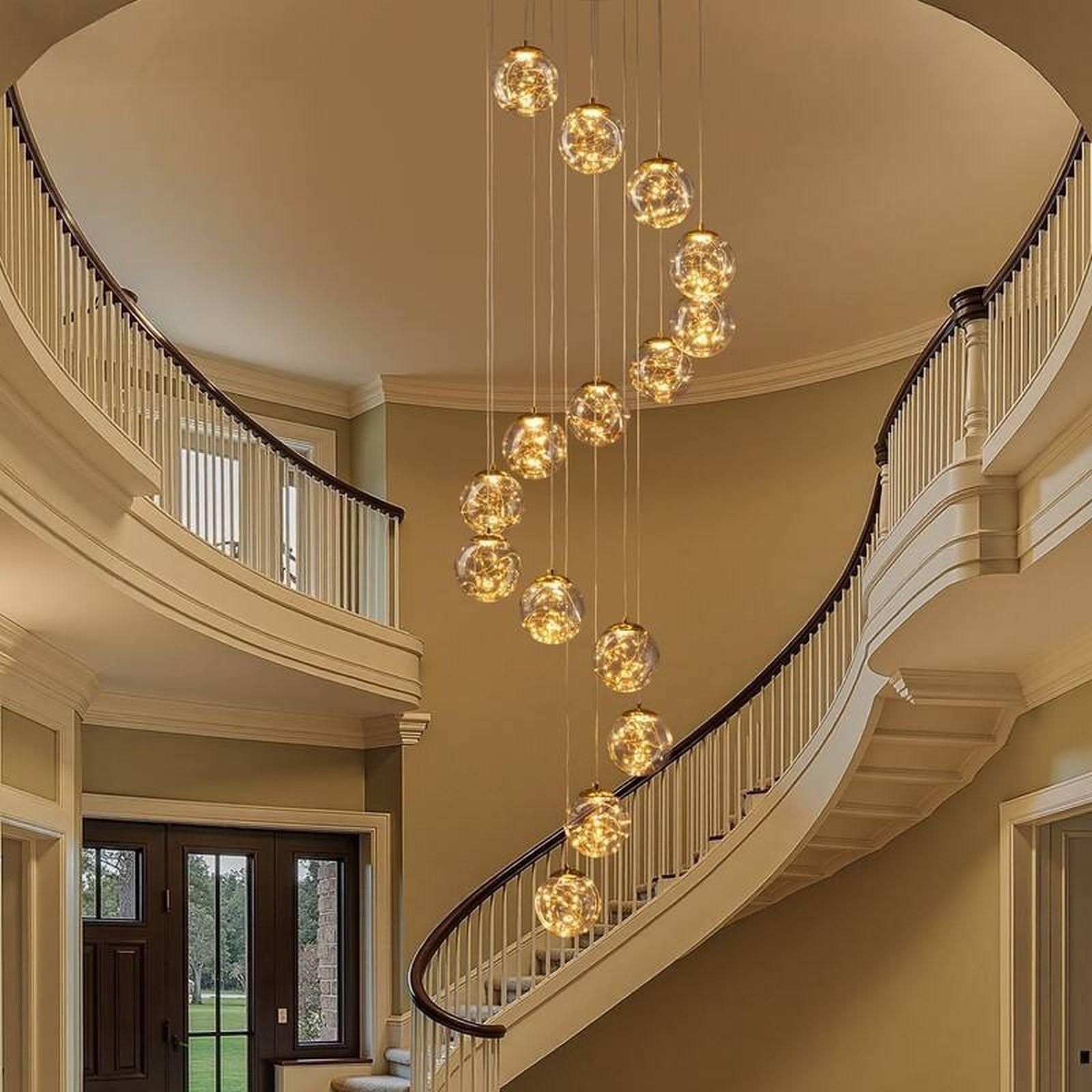 Modern Spiral Chandelier for Staircase installed along a curved foyer staircase