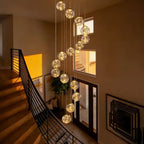 Modern Spiral Chandelier for Staircase with cascading glass globes in a tall entryway