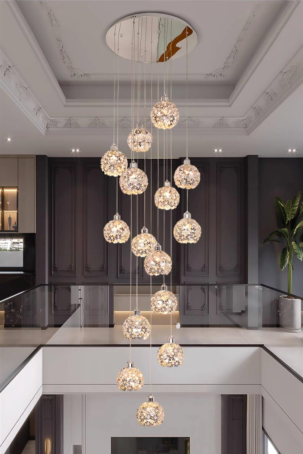 Modern Stainless Steel Petal Chandelier for Staircase hanging through an open stairwell with round crystal petal lights