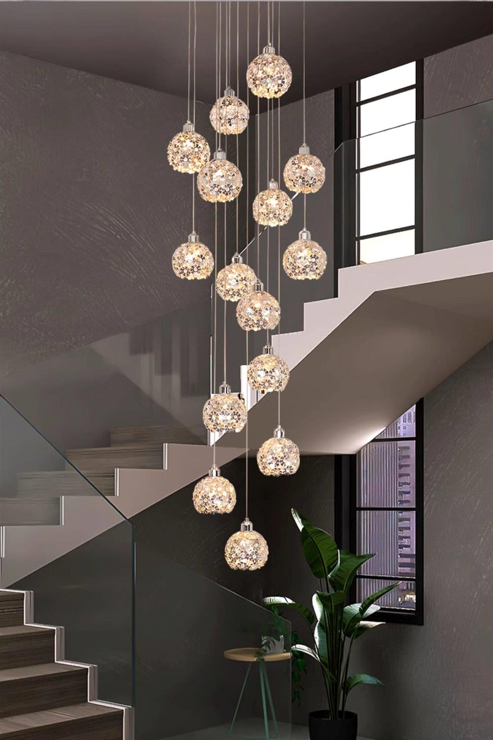 Modern Stainless Steel Petal Chandelier for Staircase with crystal petal pendants installed beside a modern staircase