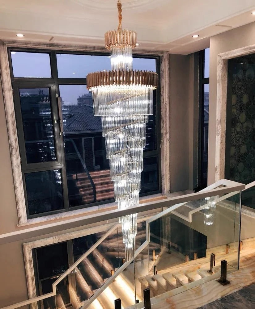 Olivia Crystal Modern Stair Chandelier hanging above a balcony staircase with glass railing