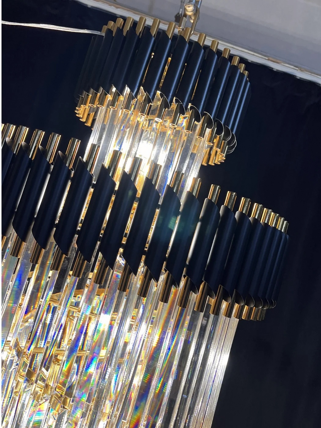 Olivia Crystal Modern Stair Chandelier close-up showing black and gold tiers with hanging crystal rods