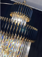 Olivia Crystal Modern Stair Chandelier close-up showing black and gold tiers with hanging crystal rods