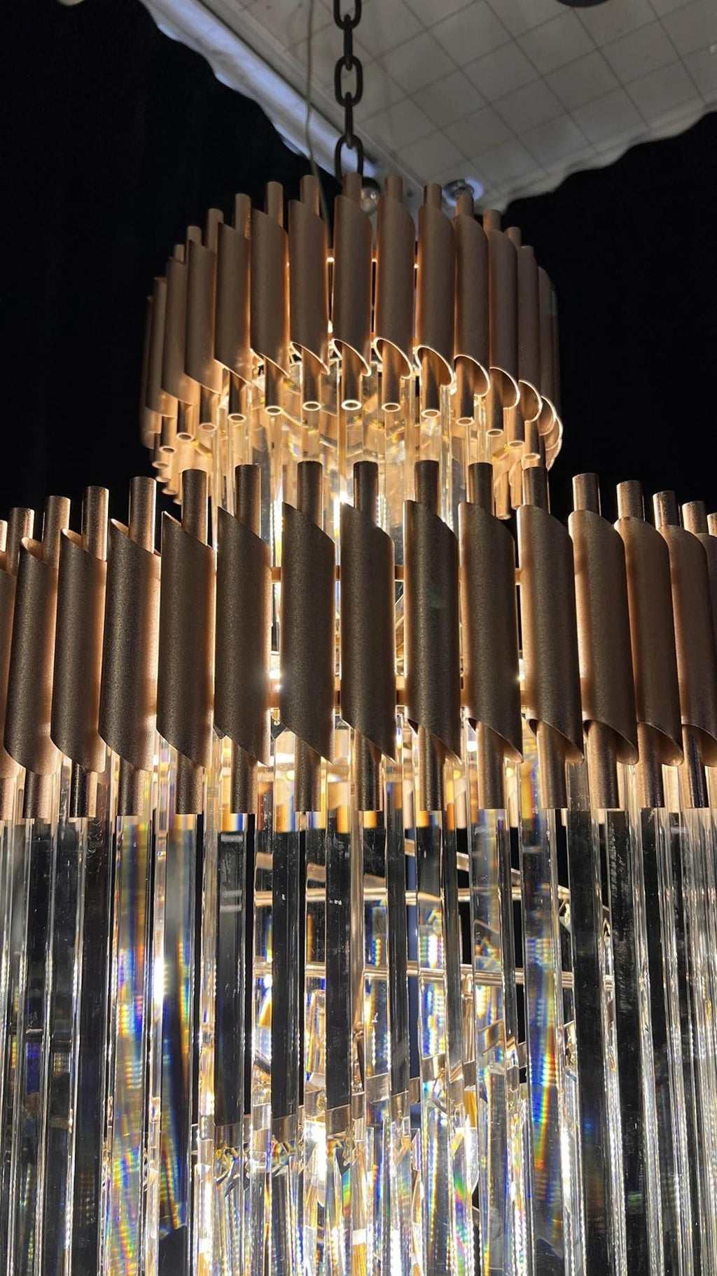 Olivia Crystal Modern Stair Chandelier close-up of black and gold upper tiers with crystal prisms