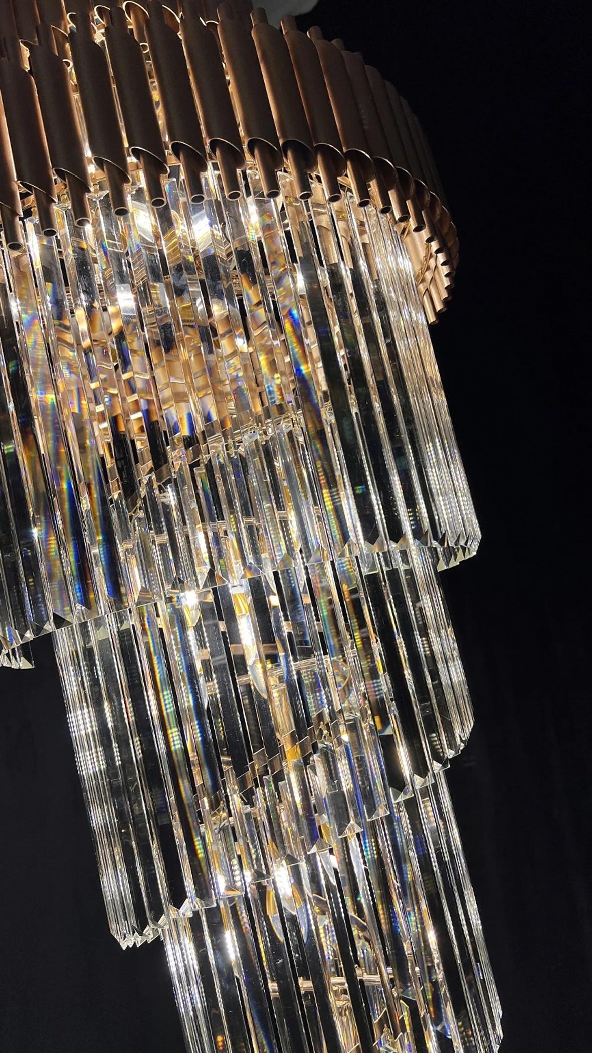 Olivia Crystal Modern Stair Chandelier close-up of hanging crystal prisms and warm LED lights