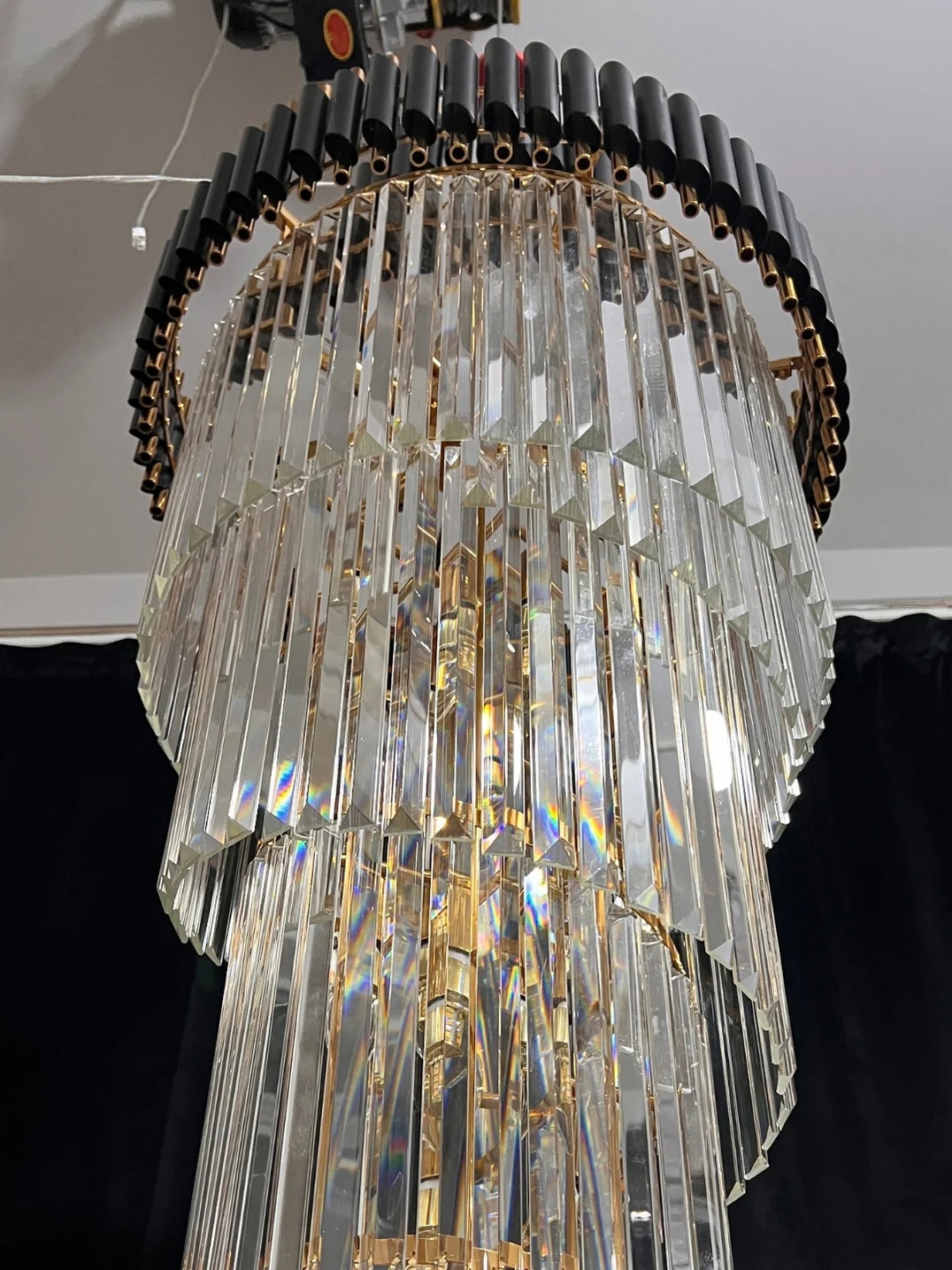 Olivia Crystal Modern Stair Chandelier close-up of the upper canopy and dense hanging crystal rods