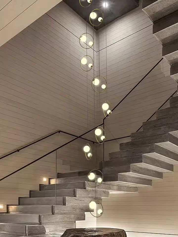 Postmodern Ring Pendant Light for Staircase shown in a modern foyer with circular pendant frames