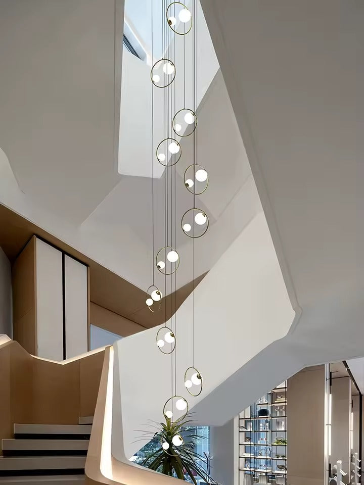 Postmodern Ring Pendant Light for Staircase vertical cluster with glowing globe lights and ring frames