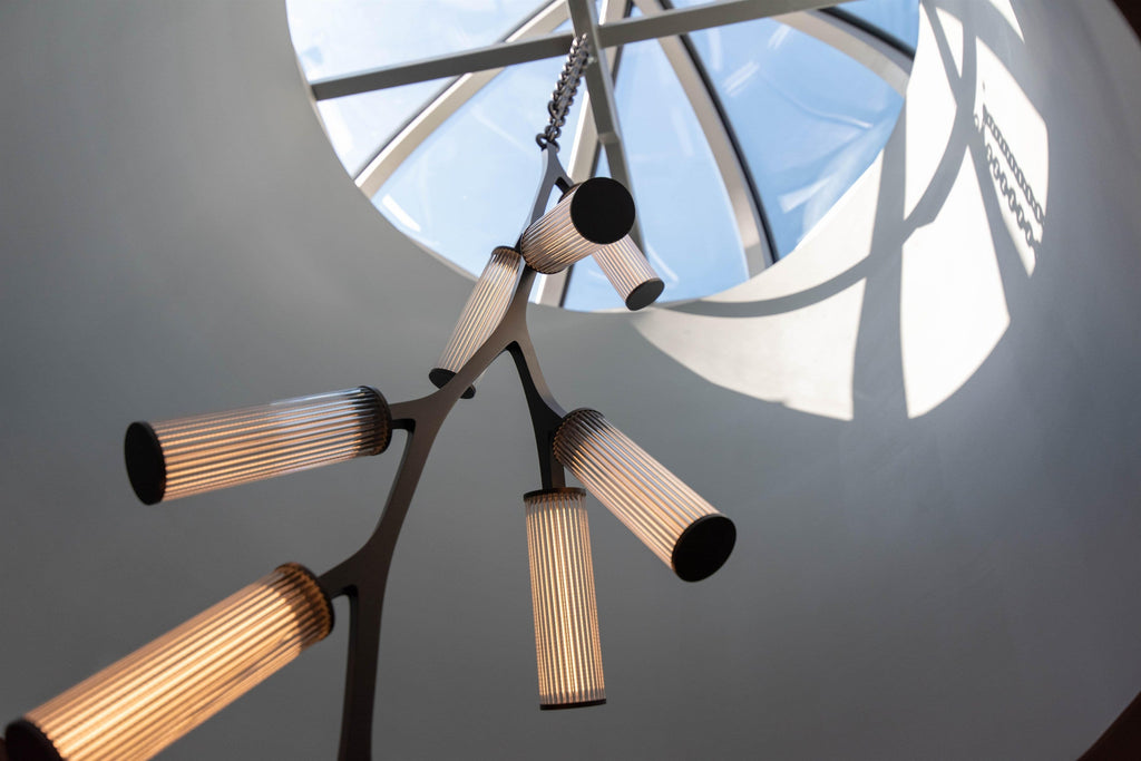Rhea Modern Simple Staircase Chandelier close-up with ribbed glass lights under a skylight