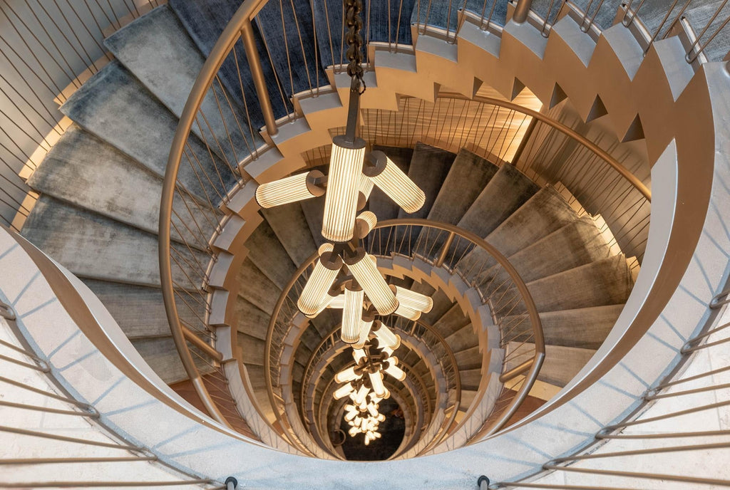 Rhea Modern Simple Staircase Chandelier suspended through a multi-level spiral stairwell