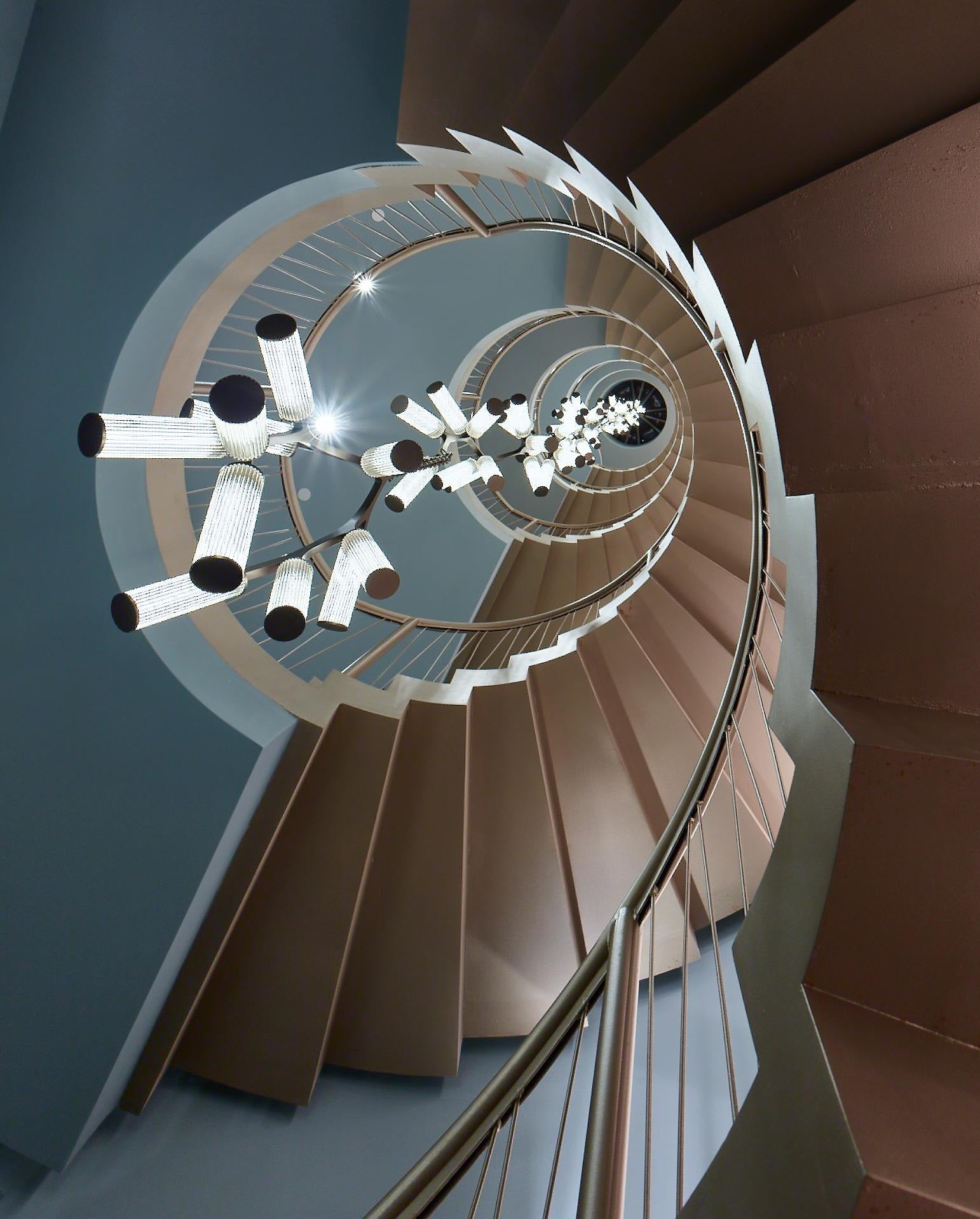 Rhea Modern Simple Staircase Chandelier viewed upward through a spiral staircase