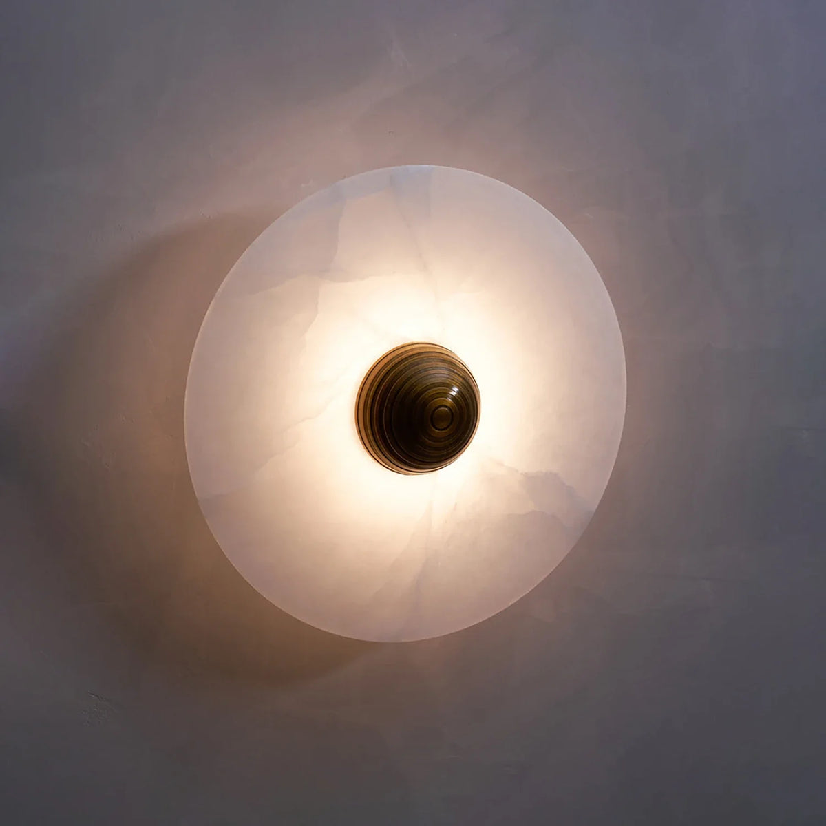 Round Alabaster Wall Lamp, single glow vignette | Bling Lighting Studio