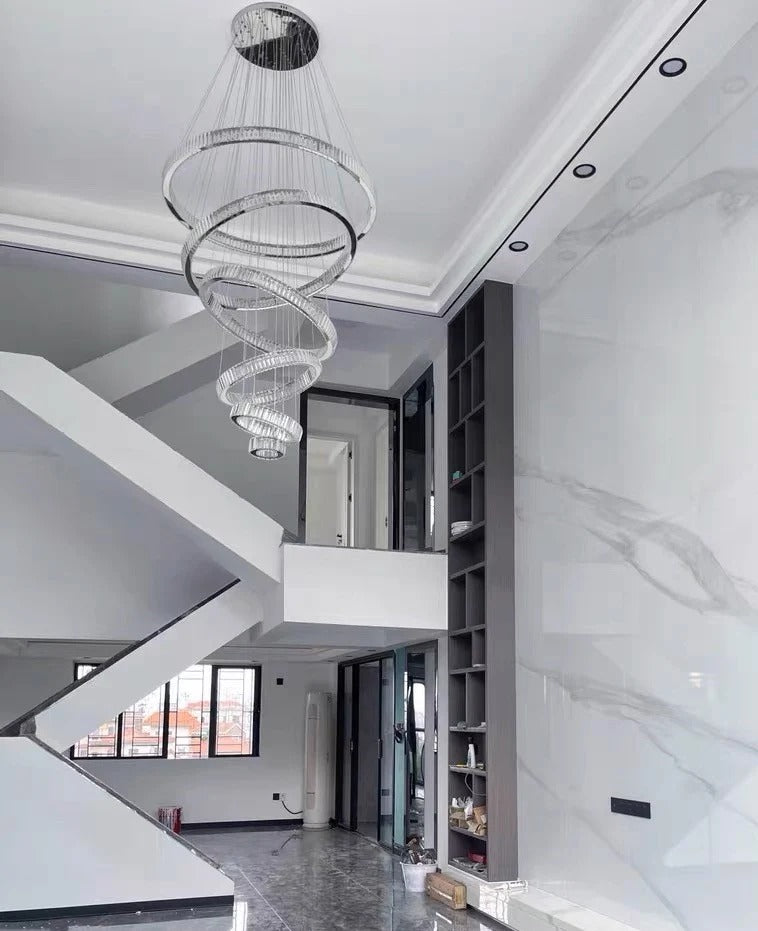 6 Tier Crystal Ring Chandelier for High Ceiling in chrome finish above a staircase foyer