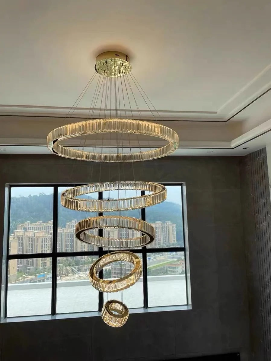 6 Tier Crystal Ring Chandelier for High Ceiling gold finish viewed from the front near a large window