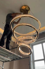 6 Tier Crystal Ring Chandelier for High Ceiling gold rings shown during installation close view