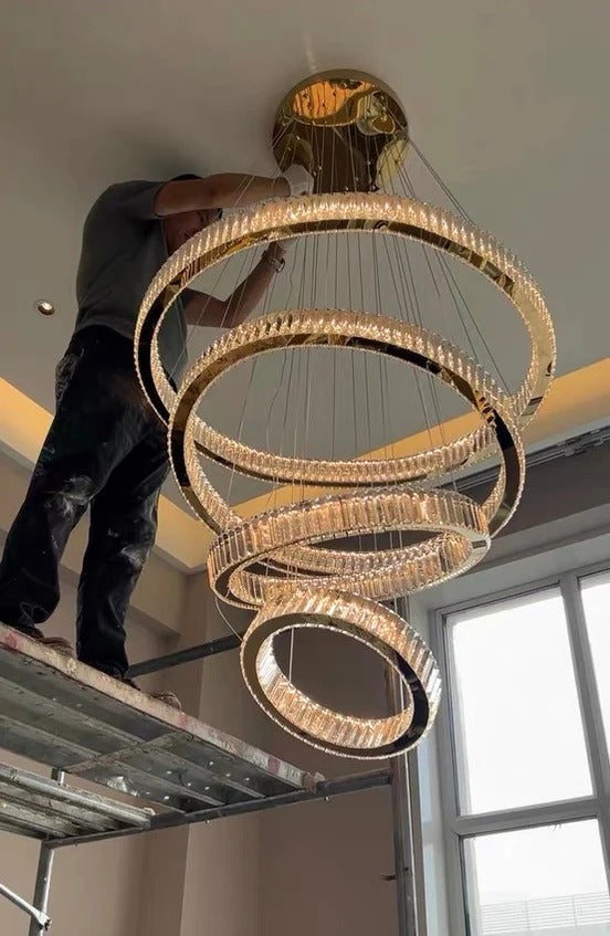 6 Tier Crystal Ring Chandelier for High Ceiling gold rings shown during installation close view