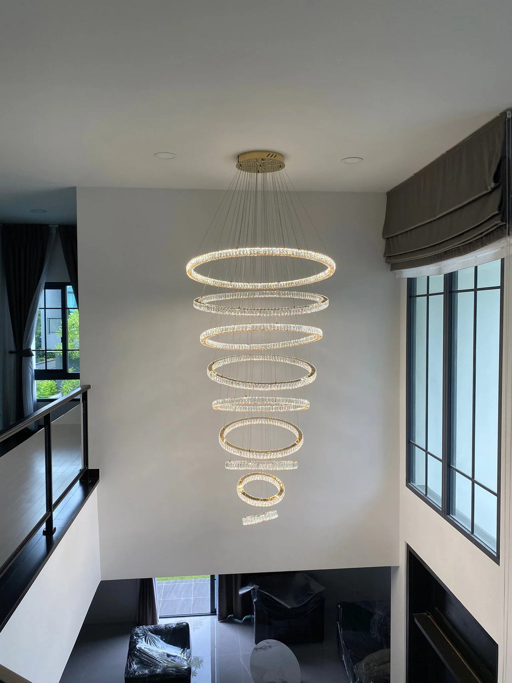 6 Tier Crystal Ring Chandelier for High Ceiling in a bright high ceiling space with daylight windows
