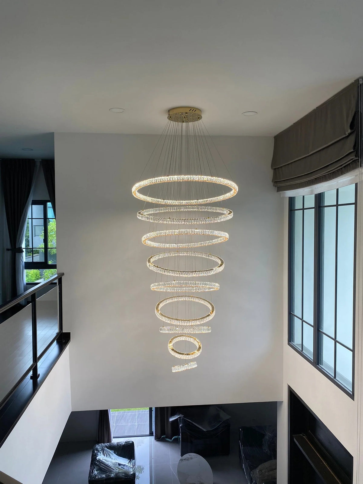 6 Tier Crystal Ring Chandelier for High Ceiling in a bright high ceiling space with daylight windows