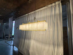 Solstice Alabaster Linear Bar Chandelier illuminated angled room view