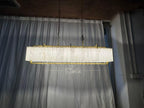 Solstice Alabaster Linear Bar Chandelier illuminated front view with translucent stone panels