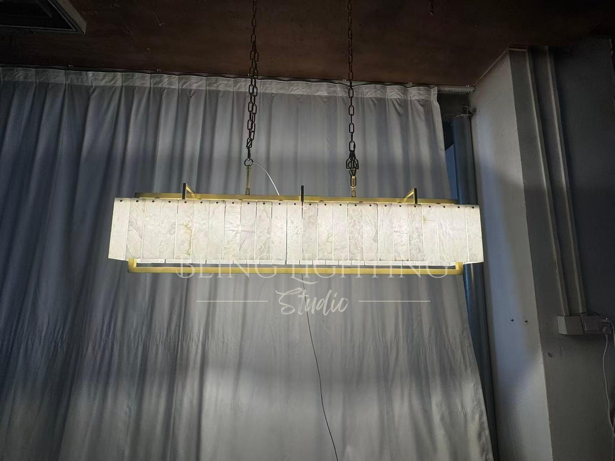 Solstice Alabaster Linear Bar Chandelier illuminated front view with translucent stone panels
