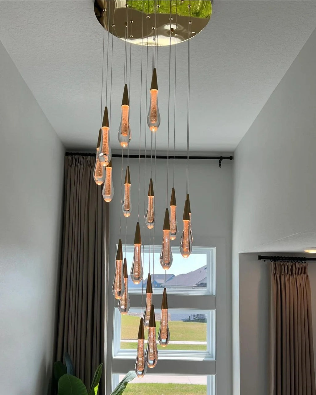Spiral Raindrop Staircase Ceiling Lighting with cascading crystal drops for a high ceiling foyer