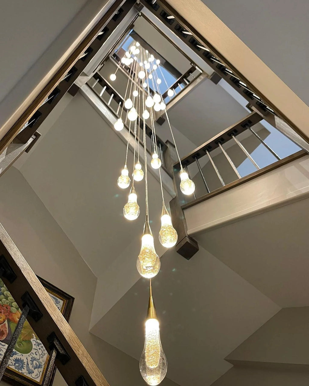 Spiral Raindrop Staircase Ceiling Lighting installed in a tall staircase foyer