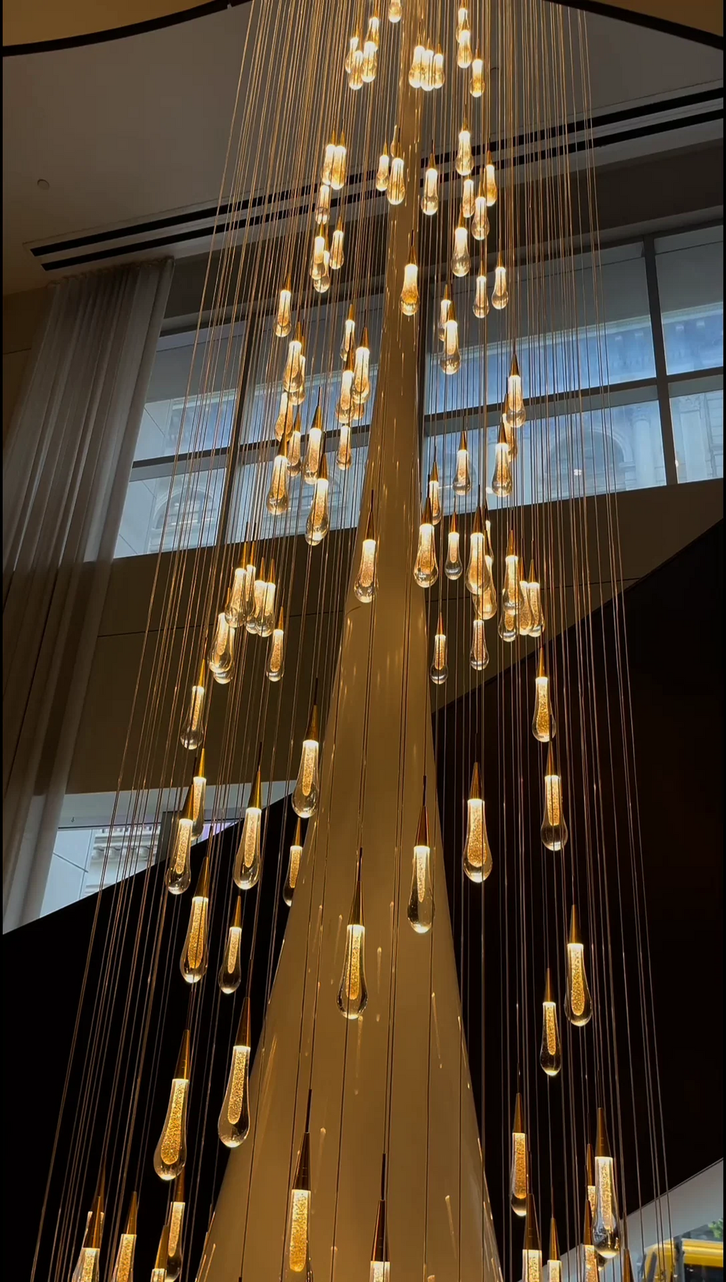 Spiral Raindrop Staircase Ceiling Lighting video still showing long cascading pendant installation