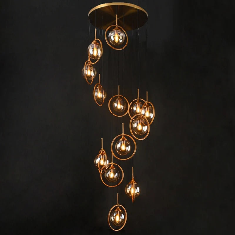 Tenza Modern Staircase Chandelier with amber spiral ball glass shades in a cascading cluster