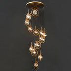 Tenza Modern Staircase Chandelier with amber glass ball pendants in a vertical spiral cluster