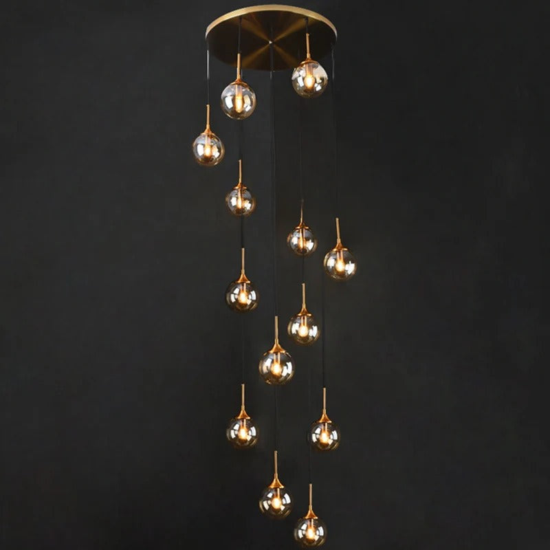 Tenza Modern Staircase Chandelier with clear glass pendants cascading from a round ceiling plate