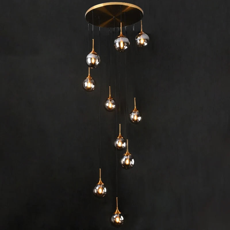Tenza Modern Staircase Chandelier with clear spiral ball glass pendants on a round gold canopy